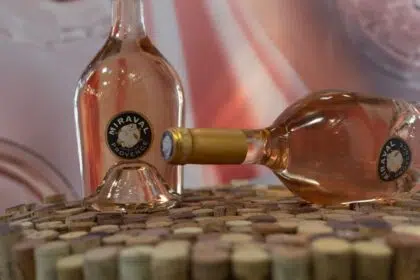 Bottles of France wine Miraval Cotes De Provence close-up on wine corks on blurred pink background. Ukraine, Zhytomyr, August, 07, 2024